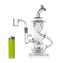 The MJ Arsenal Titan Mini Dab Rig, made of clear borosilicate glass with curved tubing and a round base, stands beside a bright green lighter on a white background. The rig includes an incycler-style quartz banger attachment.