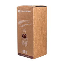 A brown box with a wood grain pattern labeled “MJ Arsenal Alpine Series - Halo Peak Top,” featuring an illustration of a borosilicate glass piece—ideal as a glass upgrade—and key features listed in white text.