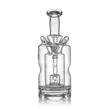 The MJ Arsenal Turbine Mini Dab Rig is a clear borosilicate glass piece with a cylindrical design, flared base, and a visible Inception Turbine Perc through its transparent body.