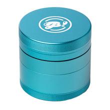 The BIGFUN! Medium Grinder is a teal, cylindrical aluminum grinder with textured grip edges and a white logo on top, shown against a plain white background—ideal for everyday use.