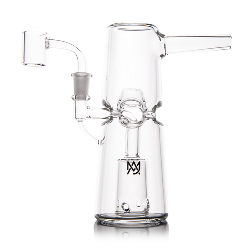 The MJ Arsenal Turret Mini Dab Rig is a clear borosilicate glass dab rig with a wide base, angled mouthpiece, side attachment, and cylindrical chamber featuring 