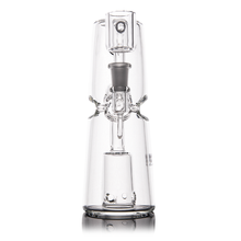 The MJ Arsenal Turret Mini Dab Rig features clear borosilicate glass, a wide base, cylindrical body, built-in percolator, and visible mouthpiece and bowl, highlighting its portable design against a white background.