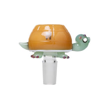 The Human Grade Animal Glass Bowl Slide is a unique 14mm water pipe accessory shaped like a cartoon turtle with a green head and tail, orange shell, and pink-tipped feet—perfect for adding fun to your setup.