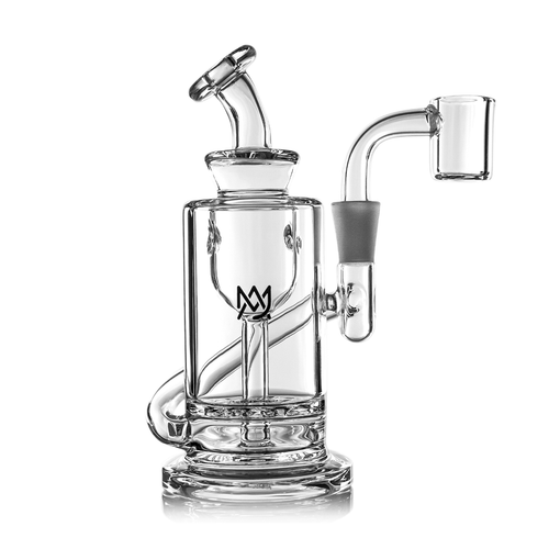 The MJ Arsenal Ursa Mini Dab Rig is a clear borosilicate glass rig with a cylindrical body, side arm, angled mouthpiece, black crown logo on the front, and quartz banger on the right. Shown against a white background.