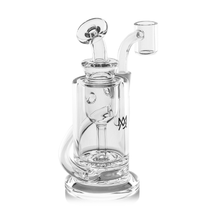 The MJ Arsenal Ursa Mini Dab Rig is a clear borosilicate glass piece with a cylindrical chamber, angled mouthpiece, bucket-style bowl, and a decorative MJ logo on the side.