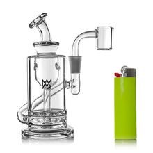 The MJ Arsenal Ursa Mini Dab Rig, made from clear borosilicate glass and featuring multiple chambers and an angled mouthpiece, is pictured beside a bright green lighter with a red button on a white background.