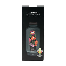 The Empire Glass Works Save the Seas Peak Top features a glass bottle filled with vibrant sea creatures and plants, surrounded by tiny trash like bottles and cans—a perfect glass attachment for your Puffco Peak.