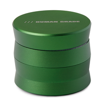 The Human Grade Grinder 3A (2" 4-Piece) is a green, cylindrical aluminum grinder with HUMAN GRADE engraved on the lid, shown against a white background.