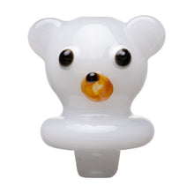 The Human Grade Bear Carb Cap is a small, glossy, white glass bear head with black eyes and a yellow-orange nose, designed as a 510 vape accessory and shown against a white background.