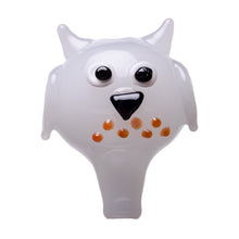 The Human Grade Owl Carb Cap is a white borosilicate glass figurine featuring big black and white eyes, a black beak, and orange spots—an adorable owl design accessory perfect for dab rigs. Shown on a white background.
