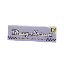 A lavender Blazy Susan Purple Rolling Papers 1 1/4 pack, featuring bold black and white text with a checkered design bottom—perfect for those seeking premium quality in their deluxe rolling kit.