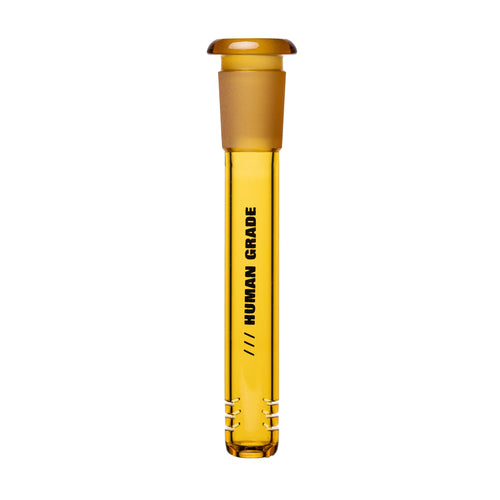A transparent amber glass Human Grade Color Downstem (14MM) with a stopper and black HUMAN GRADE label stands upright on a white background—perfect as a precise downstem replacement for optimal airflow.
