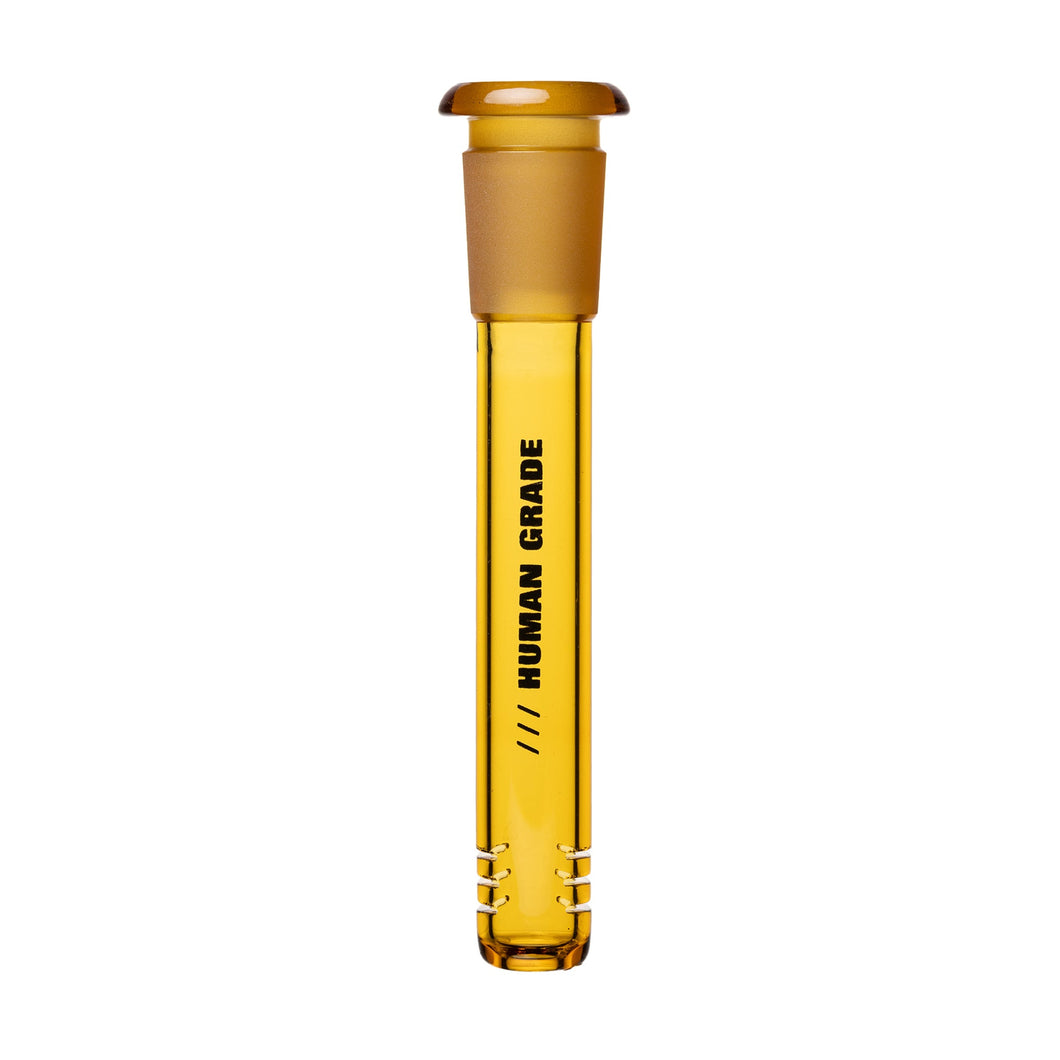 A transparent amber glass Human Grade Color Downstem (14MM) with a stopper and black HUMAN GRADE label stands upright on a white background—perfect as a precise downstem replacement for optimal airflow.