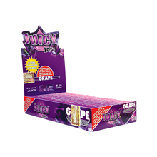 A display box of Juicy Jay's Flavored Papers in grape flavor, with purple packaging, grape graphics, and promo text. The open box reveals individually wrapped papers inside, each triple-dipped for extra flavor.