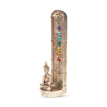 The Fantasy Tower Incense Burner is a hand-painted resin incense holder featuring a golden Buddha base and seven colorful chakra stones arranged vertically along its ornate tower column.