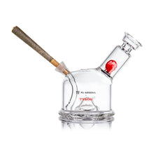 The MJ Arsenal x Tyson 2.0 Punch-Out is a clear borosilicate glass bubbler with Tyson branding, a side slot for holding a joint, and a red face graphic inside—an iconic Mike Tyson collectible for any fan.