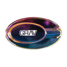 The Grav Ellipse Ashtray features an iridescent, oval design with a white GRAV logo at the center and a single groove for holding your cigarette or cigar—an eye-catching statement piece.