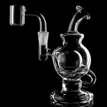 The MJ Arsenal Atlas Mini Dab Rig, made from clear borosilicate glass with a curved mouthpiece, round chamber, handle, and attached banger, is displayed against a black background—offering durability and style in each session.
