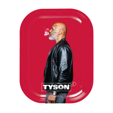 A bearded, tattooed man in a black leather jacket stands in profile against a red backdrop, exhaling smoke. "TYSON 2.0 Rolling Trays" is displayed in bold white letters at the bottom for promotional use.