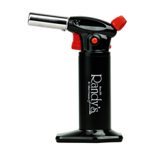 A black Randy's Torch with an ergonomic design features a silver nozzle, red ignition button, safety lock, and upright stance. The front displays "Randy's" in white text.