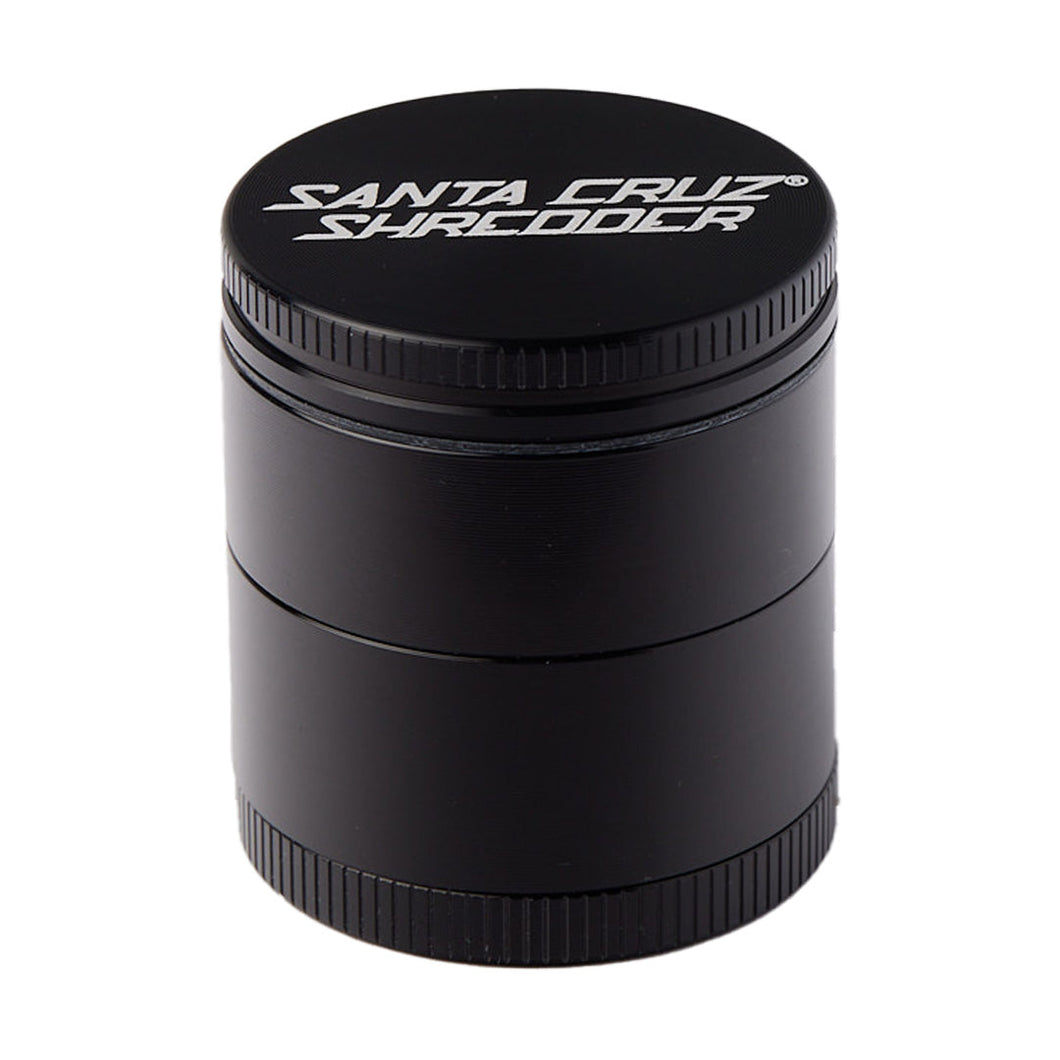 The Santa Cruz Shredder Small 4-Piece Grinder, made of black anodized aluminum with white logo on the lid, is designed for grinding herbs and is shown against a white background.