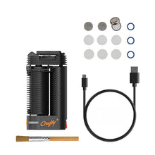A black Storz & Bickel Crafty+ Vaporizer USB-C Charger, with a cleaning brush, extra screens, filters, and blue O-rings, is neatly arranged on a white background.