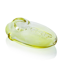 The Grav Pebble Spoon is a discreet, smooth, rounded hand pipe in translucent yellow and clear glass with "GRAV" embossed on it, photographed on a white background.