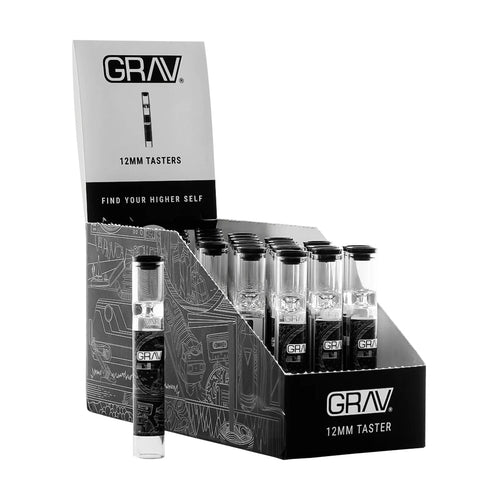 A GRAV 12mm Glass Tasters Display holds multiple 12mm glass tasters in clear tubes, with one upright taster pipe displayed in front of the black and white box labeled accordingly.