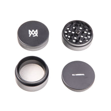 Four pieces of the MJ Arsenal 4 Piece Grinder are displayed on a white background. Two lids feature MJ Arsenal logos, while the other sections include sharp teeth, a mesh screen, and a collection chamber in this aluminum grinder.