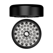 The Flower Mill 2" Next Gen Premium Grinder is a black two-piece circular grinder, shown open, with a metal grinding surface featuring multiple round holes and medium mill plate teeth.