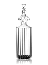 The GRAV® Monarch Gravity Bong features clear ribbed borosilicate glass with vertical lines, fluted shoulders, and a faceted stopper. Its elegant, symmetrical design combines style with function.