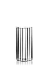 The GRAV® Monarch Gravity Bong, made from clear borosilicate glass with vertical grooves, stands empty and centered on a white background, its cylindrical shape lightly reflecting light at the base.