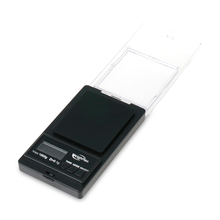 The WeighMax Scales is a compact digital scale featuring a black weighing platform, back-lit LCD display, and clear plastic flip cover. It offers precise measurement with a 750g capacity and is shown on a white background.