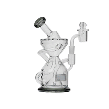 The Tyson Knockout Dab Rig features clear borosilicate glass, a twisted hourglass shape, angled mouthpiece, and side chamber—standing out boldly against a white background.