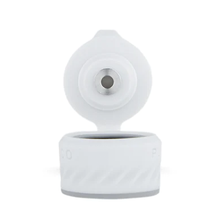 The Puffco Peak Pro Joystick Cap is shown open, revealing its central nozzle for directional airflow. The white cap features a textured grip and is displayed against a plain white background.