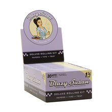 A purple and black box labeled "Blazy Susan Purple Rolling Papers" features a retro-style woman and indicates the pack includes king size slim rolling papers, tips, and a tray.