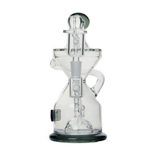The Tyson Knockout Dab Rig is a clear, hourglass-shaped borosilicate glass water pipe with multiple chambers, a rounded base, intricate glasswork, and a cylindrical mouthpiece designed for smoking.