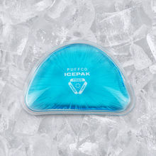 A blue, semi-circular gel ice pack labeled Puffco Journey Bag sits on clear ice cubes—perfect for keeping your Puffco Peak Pro or other key accessories cool.