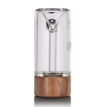 The MJ Arsenal Alpine Series - Steamboat Bubbler features clear borosilicate glass with an inverted cone design, standing upright on a round wooden base, displayed against a white background.