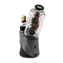 The Empire Glass Works Save the Seas Peak Top is a modern gray and black electronic dab rig featuring a clear glass chamber with colorful, glow-in-the-dark floral designs, compatible as a Puffco Peak glass attachment. Shown on a white background.