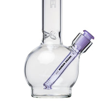 A clear glass water pipe with a round base features a removable Human Grade Color Downstem (14MM) in purple, labeled HUMAN GRADE for optimal airflow, shown on a white background.