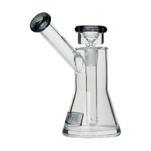 The Tyson Upper Cut Bubbler is a clear borosilicate glass water pipe with a beaker base, angled mouthpiece, and removable bowl. It features dark accents on the mouthpiece and bowl plus a small rectangular label on the base.