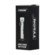 A black rectangular box with Tyson 2.0 branding displays the Tyson Jab One Hitter, featuring a clear borosilicate glass pipe inside. "JAB ONE HITTER" is printed in white at the bottom, highlighting this portable smoking accessory.