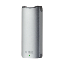 The Davinci ARTIQ 510 Thread Battery Vape is a sleek, silver portable vaporizer featuring the DAVINCI logo, a small green indicator light, a minimalist curved design, and an elongated air path for smoother draws.