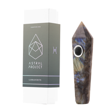A Gemstone Pipe made from labradorite, featuring a replaceable mesh bowl, stands upright beside an Astral Project box labeled "Labradorite" on a white background.
