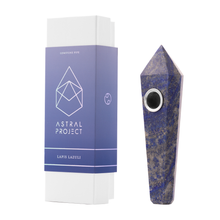 A Gemstone Pipe made of lapis lazuli with a replaceable mesh bowl stands upright beside a white and purple Astral Project Gemstone Pipe Lapis Lazuli box.