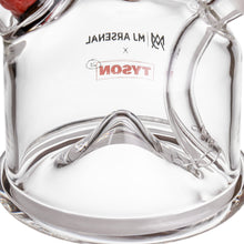 Close-up of the MJ Arsenal x Tyson 2.0 Punch-Out Cone Bubbler in clear borosilicate glass, with TYSON printed upside-down in red and MJ ARSENAL in black, both reflected on the thick base and curved connected tubes.