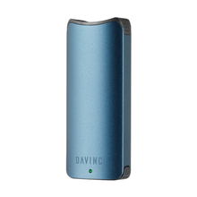 The Davinci ARTIQ 510 Thread Battery Vape is a sleek, metallic blue portable vaporizer with rounded edges, an elongated air path for smooth draws, "DAVINCI" engraved near the bottom, and a small green indicator light below the logo on a plain white background.