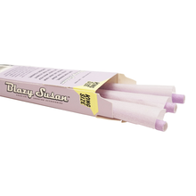 A partially opened purple box labeled Blazy Susan Purple Paper Cones displays several king size pre-rolled cones with purple tips, perfect for an elevated smoking experience.
