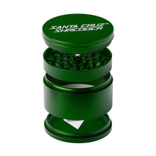 A Santa Cruz Shredder Large 4-Piece Grinder in green is shown separated into its lid, grinding teeth, mesh screen, and bottom compartment.
